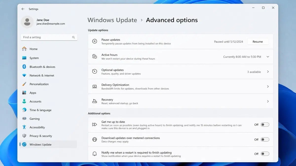 Windows 11 Settings showing Windows Update Advanced options with feature update deferral settings and a paused update status